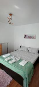 a bedroom with a bed with towels on it at Apartament Nina in Mangalia