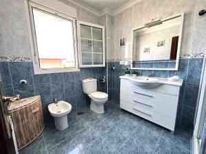 a bathroom with a toilet and a sink and a mirror at Villa Tarredonas - 12803 in Ajo