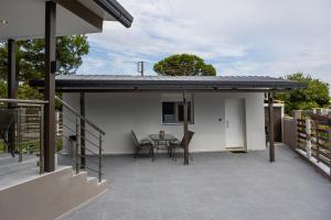 a patio with a table and chairs on a house at K&M Villas in Nea Kallikrateia