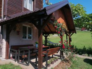 a wooden pavilion with a table and a bench at Vikendica moonlight in Zaovine