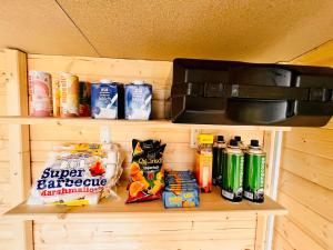a shelf with food and drinks and a microwave at Beheiztes Bubble Tent am See - Sternenhimmel in Wadersloh