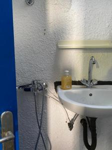 a bathroom sink with a soap bottle on it at Poudras Amazing View Caldera in Órmos Athiniós