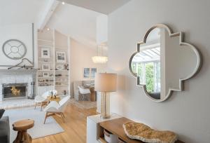 a living room with a large mirror on the wall at 3897 Driftwood home in Carmel