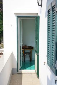 an open door to a dining room with a table at Dimora Storica Villa Pasquale Capri in Capri