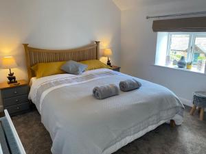 a bedroom with a large bed with two towels on it at Idillic Two bed country cottage in Kirkby Thore