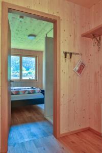 a room with a door leading to a bedroom at Bergreich Appartement 1 in Schoppernau