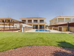 a large house with a lawn in front of it at Amazing frontline beach villa in Larnaca