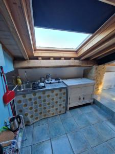 an attic kitchen with a sink and a skylight at Monti D'Abruzzo holiday home in Crecchio