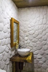 a bathroom with a white sink and a mirror at Hotel Cabañas Club Sierra Limón in Santa Marta