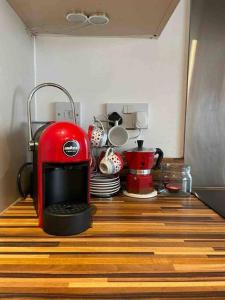 a red toaster sitting on top of a kitchen counter at Central London apartment in London