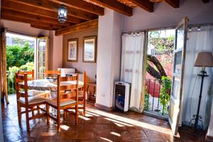 a dining room with a table and chairs and windows at Hotel Ana Catalina and Suites in San Miguel de Allende