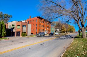 an empty street in a town with a building at Navarre Apartments in Des Moines