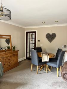 a living room with a wooden table and chairs at Wharf Cottage in Coalbrookdale