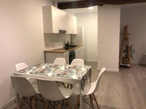 a kitchen with a table and chairs in a room at Apartamento centro Santander A in Santander