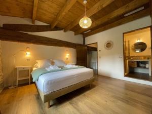 1 dormitorio con 1 cama en una habitación con techos de madera en Mas Millésime - Gîte Mourvèdre - 6 pers - Piscine privative - St Remy de Provence, en Mas blanc des Alpilles