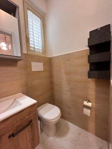 a bathroom with a toilet and a sink at La Foggia seaside paradise in Siculiana
