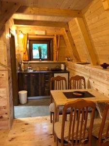 a kitchen with a table and chairs in a cabin at Family S house - Komarnica in Šavnik