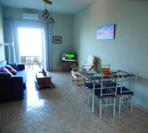 a living room with a couch and a table with chairs at TSOUMAS HOUSE in Kastrosikia +14 photos
