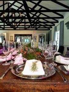 a table with wine glasses and napkins on it at Silver Mist Guest House, Country Inn and Herberg in Kaapsehoop
