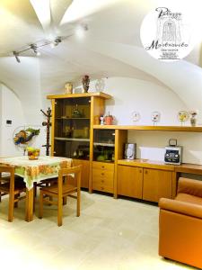 una cucina con mobili in legno e tavolo di Palazzo Mastrovito a Martina Franca