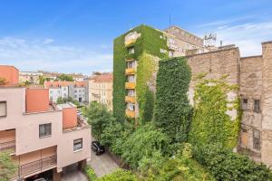 a building with ivy on the side of it at Elegant City Escape - Modern & Central in Bratislava