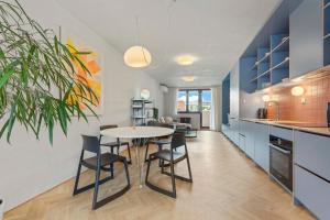 a kitchen and dining room with a table and chairs at Elegant City Escape - Modern & Central in Bratislava