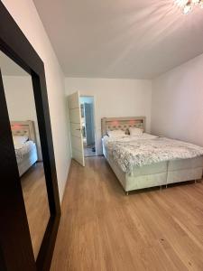 a bedroom with a bed and a mirror at Padriku Apartment with a balcony,near to central,Self Check In 24 7,FREE Parking in Tallinn