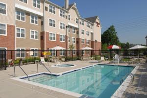 a swimming pool in front of a building at Residence Inn Arundel Mills BWI Airport in Hanover