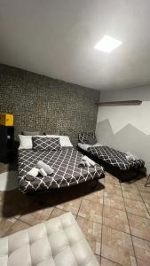 a bedroom with two beds and a wall at B&B Universo in Codogno