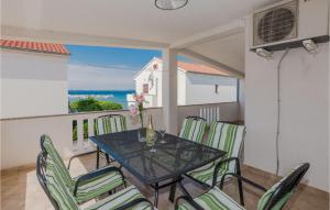 a table and chairs on a balcony with a view of the ocean at Amazing Home In Privlaka With House Sea View in Privlaka
