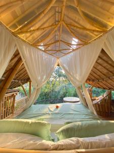 a room with a bed in a tent at Wahem Eco Bamboo in Ubud