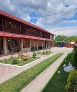 a building with ducks in front of it at Casa Cristina in Cârțișoara