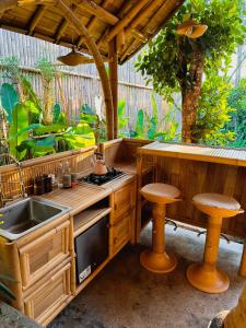 an outdoor kitchen with a sink and a stove at Wahem Eco Bamboo in Ubud