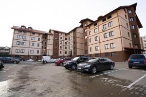 a parking lot with cars parked in front of buildings at Alex 2 Apartament in Iaşi
