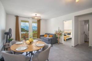 a living room with a table and chairs and a couch at Navira - Appartement le Pavillon in Le Lamentin