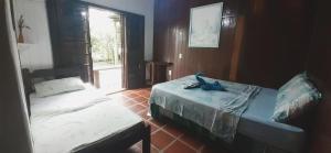 Postel nebo postele na pokoji v ubytování Pousada D'Aconchego Nova Brasilia