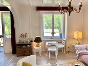 a living room with a table and chairs at Chasa Sassalbo in Poschiavo
