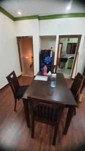 a dining room with a wooden table and chairs at Newly renovated & furnished 2-Bedroom MVP colony in Visakhapatnam