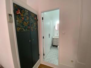 baño con puerta verde y espejo en União - Guest House, en Tomar