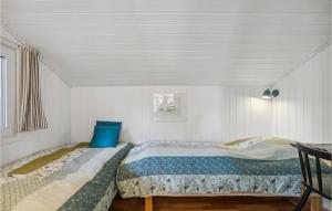 a bedroom with two beds in a room at 3 Bedroom Nice Home In Jerup in Jerup