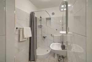 a white bathroom with a sink and a toilet at Bojana Apartments in Cavtat +13 photos