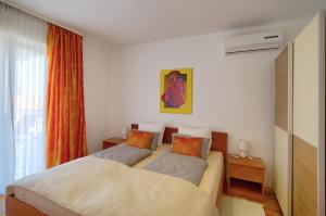a bedroom with two beds and a window at Bojana Apartments in Cavtat