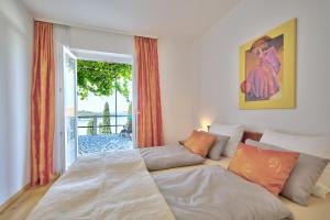 a bedroom with a bed and a couch at Bojana Apartments in Cavtat