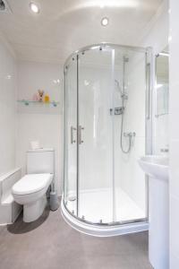 een badkamer met een douche, een toilet en een wastafel bij The Woodlands Hotel in Sidmouth