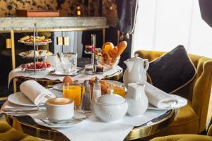 a table with breakfast foods and coffee on it at Hôtel Manolita Paris in Paris