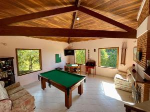 a living room with a pool table in it at Chácara Mira Flores in Atibaia