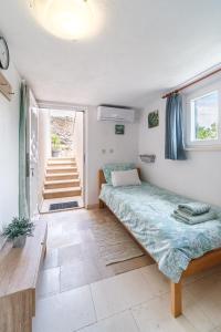 a bedroom with a bed and a staircase in it at Villa Maria Škrip in Škrip