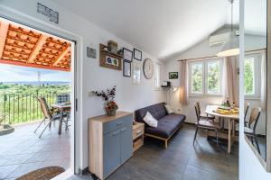 a living room with a couch and a table at Villa Maria Škrip in Škrip