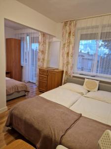 a bedroom with two beds and a window at Stella Maris in Karwia