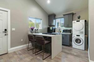 a kitchen with a washer and dryer next to a counter at Cozy Private Guest House Pet Friendly Free Parking in Los Angeles